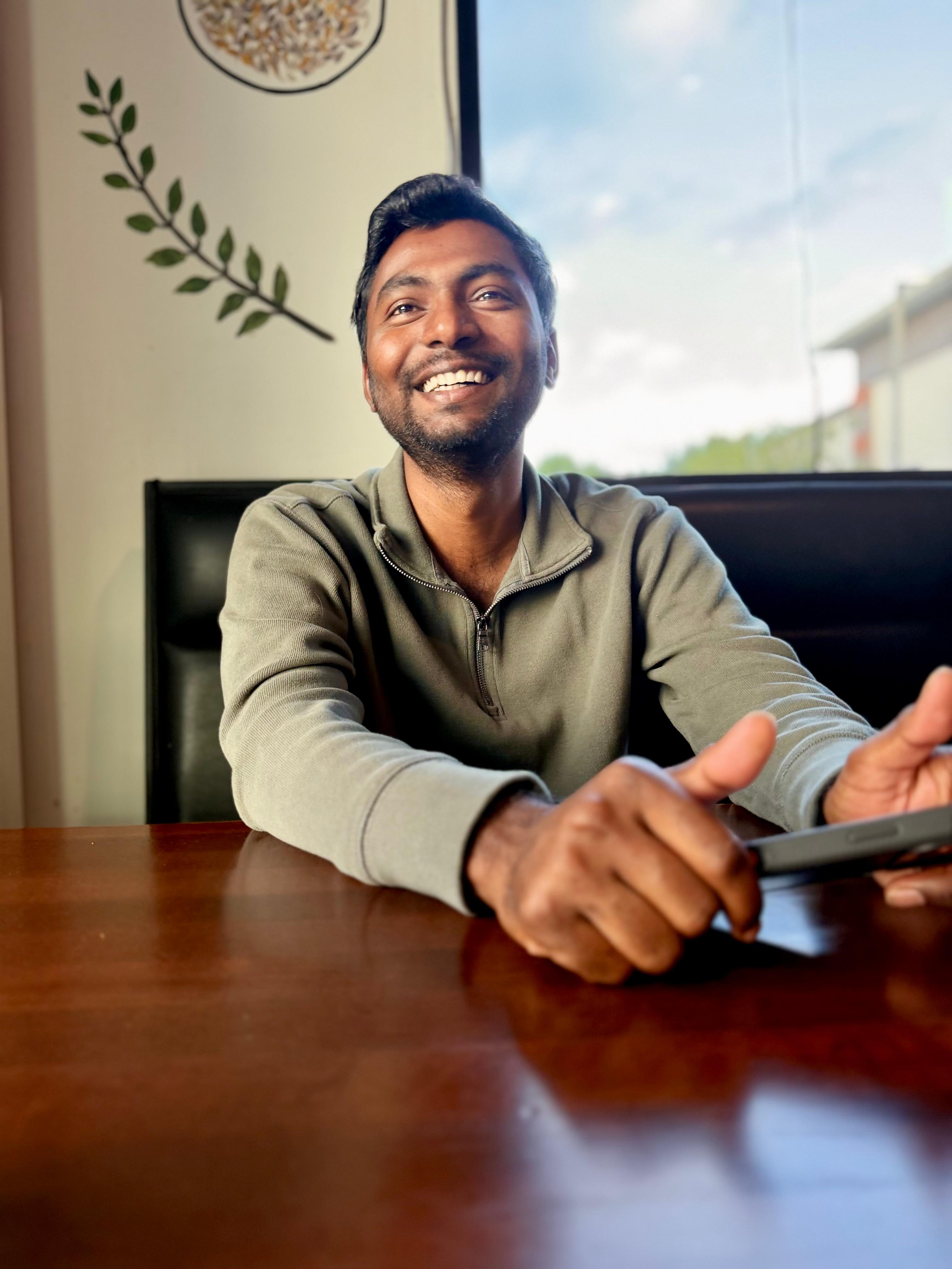 Srikanth Guduri smiling indoors